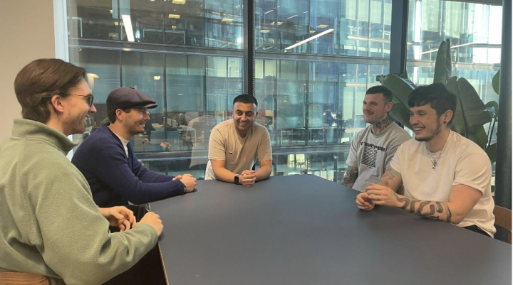 men gathered on the table conversing 